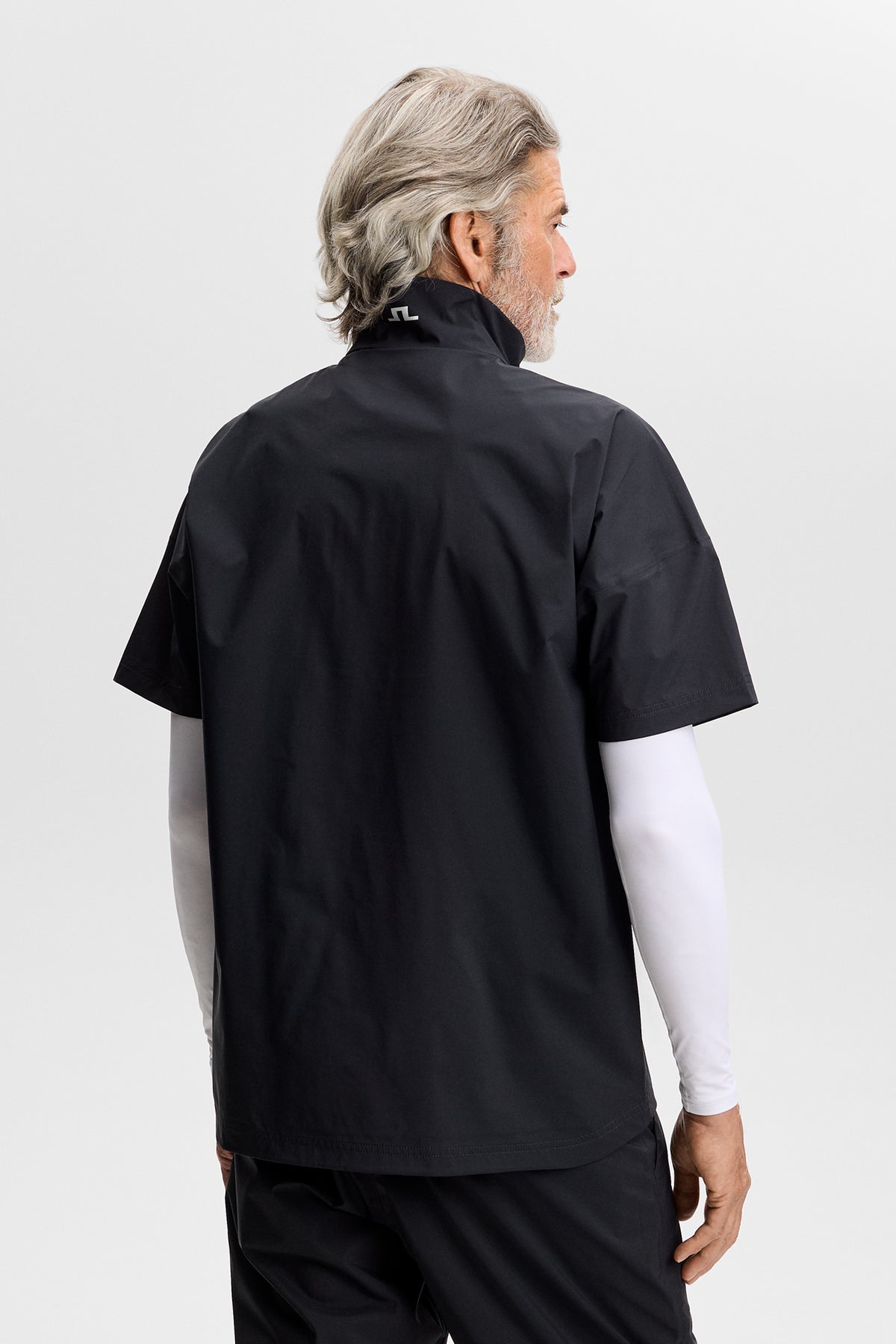 J.Lindeberg Shay Rain Shirt Black – side view showing streamlined silhouette and branding